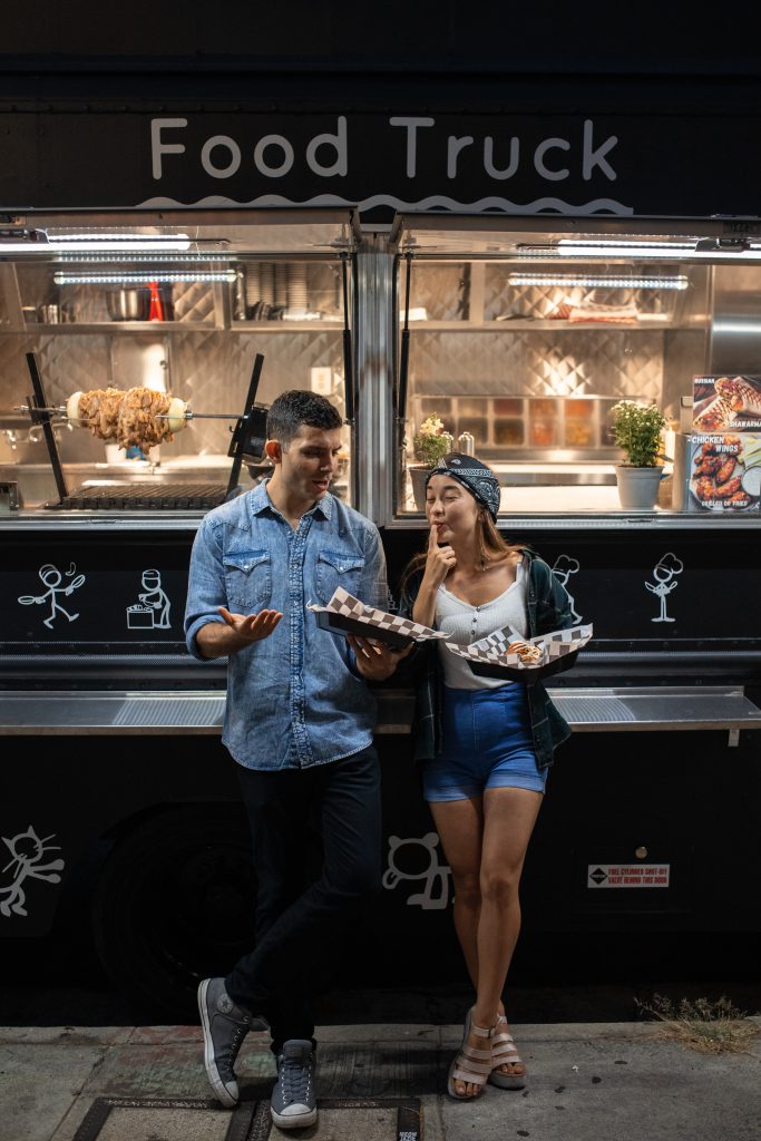 People eating at a food truck