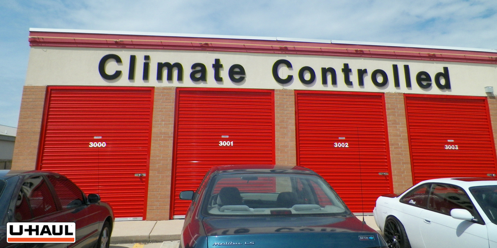 Climate controlled U-Haul storage center. There are four different storage spots numbered 3000, 3001, 3002, and 3003. There are also three cars parked in front of these storage spaces.