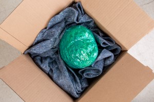 A guitar that is completed wrapped and packed in a box for shipping.