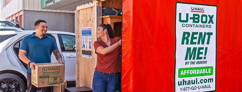Man and woman loading their U-Box portable moving and storage container