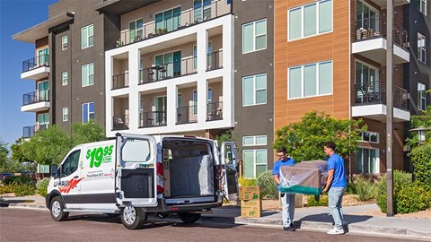 Two Moving Helpers loading furniture