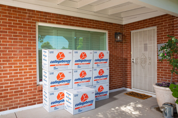 A stack of Collegeboxes that were delivered to a student's home on the door step.