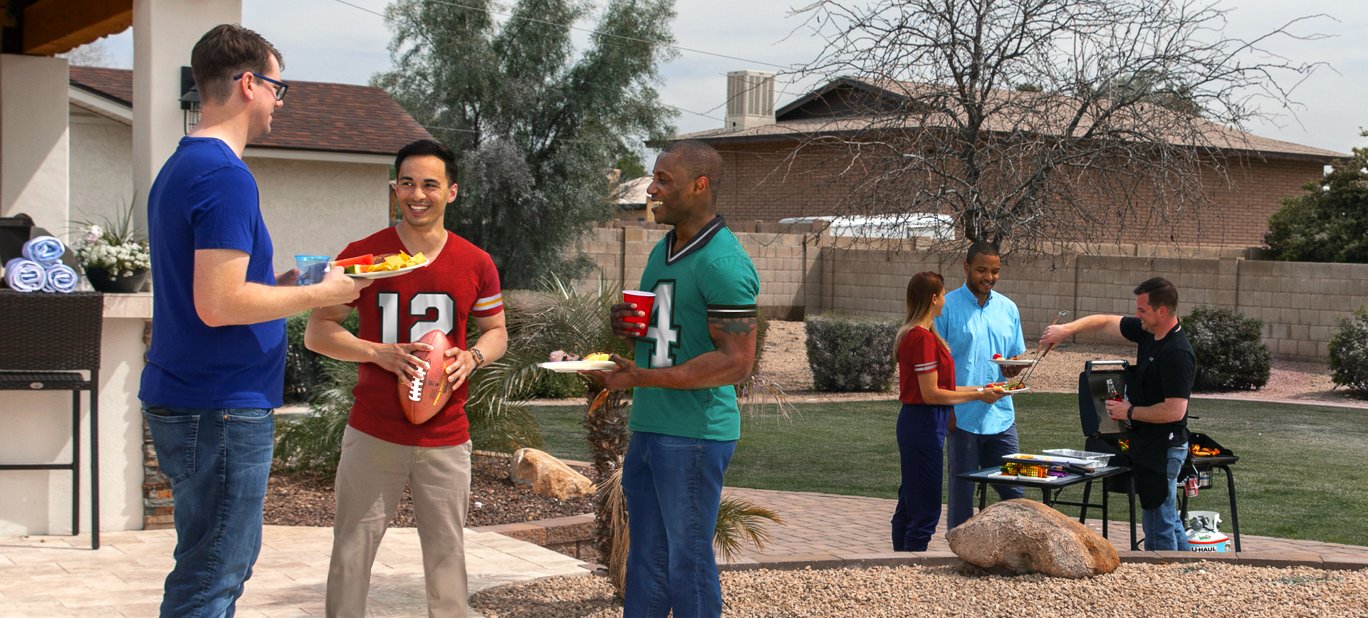 People enjoying a backyard tailgate party powered by U-Haul propane.