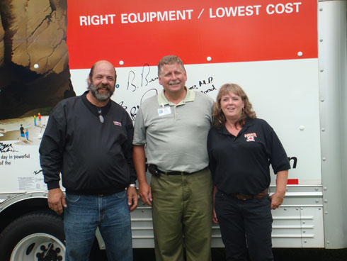 Omar Cormier and Linda Armitage of U-Haul Dealership Linome Auto and Electric LTD, attended the unveiling and posed with Bruce Bennett in front of the new SuperGraphic.