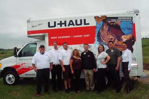 Co. 730 Area Field Managers (AFMs) Jerry Winget, Anthony Stansberry and Doug Graham, Media and Public Relations Director Joanne Fried, MCP Mike Hale, Media and Public Relations Specialist Nicole Shropshire, Executive Assistant (EA) Steve Circo and area district vice president (ADVP) Yvette DaLuz in front of the SuperGraphic.