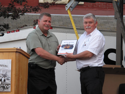 MCP Bennett, presents a plaque to the Honourable Charlie Parker, MLA Pictou West. 