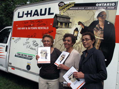 Descendents of the Reverend Henson, Kathy Jenkins, Barbara Carter and Cathy Carter pose in front of the Ontario SuperGraphic aft