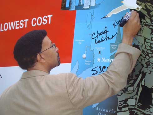 Keith Stokes, executive director of the Newport County Chamber of Commerce, signs the truck.