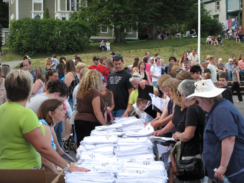 U-Haul System members pass out T-shirts and PR Kits to guests attending the unveiling event. 