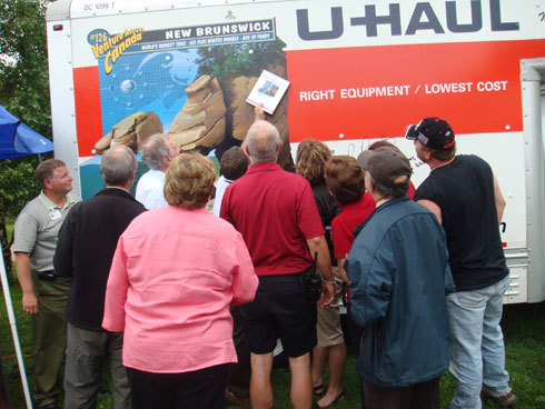 Dignitaries and guests gather in front of the SuperGraphic to try and find Sammy U.