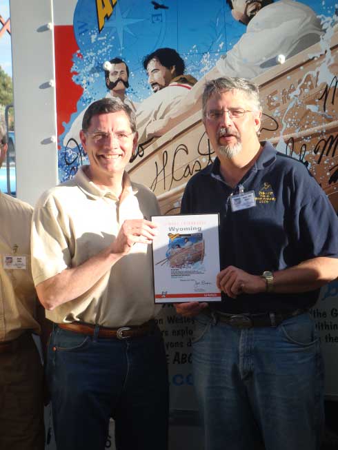 U.S. Senator John Barrasso and Senator John Hastert pose in front of the unveiled U-Haul truck. 