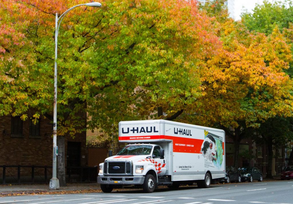 U-Haul truck driving down road.