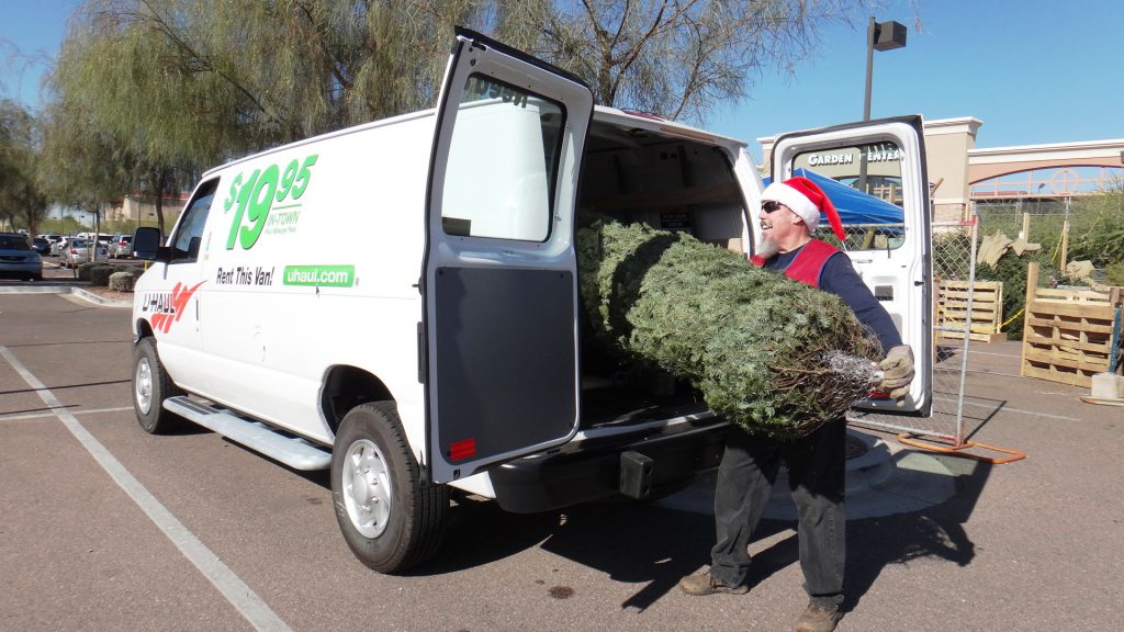 Loading up a U-Haul cargo van with a Christmas tree.